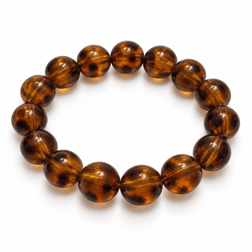 Bruine Amber kralenarmband met warme tinten en goudkleurige details van Hippe Kraal
